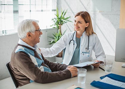 Doctor talking to elderly patient