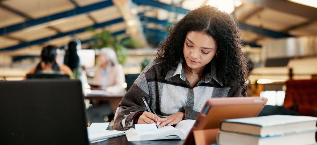 Young female student studying in open space